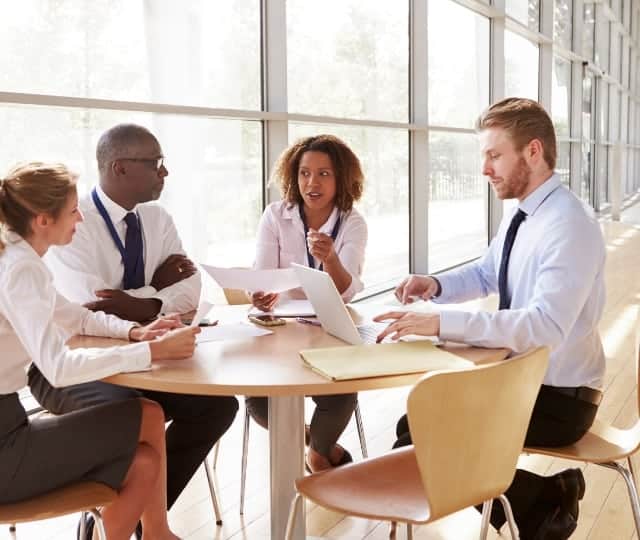 professionals discussing work around table